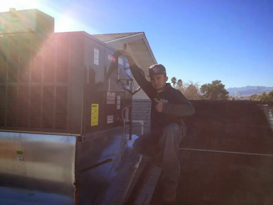 HVAC technician performing HVAC Inspection on a rooftop unit in Red Chute